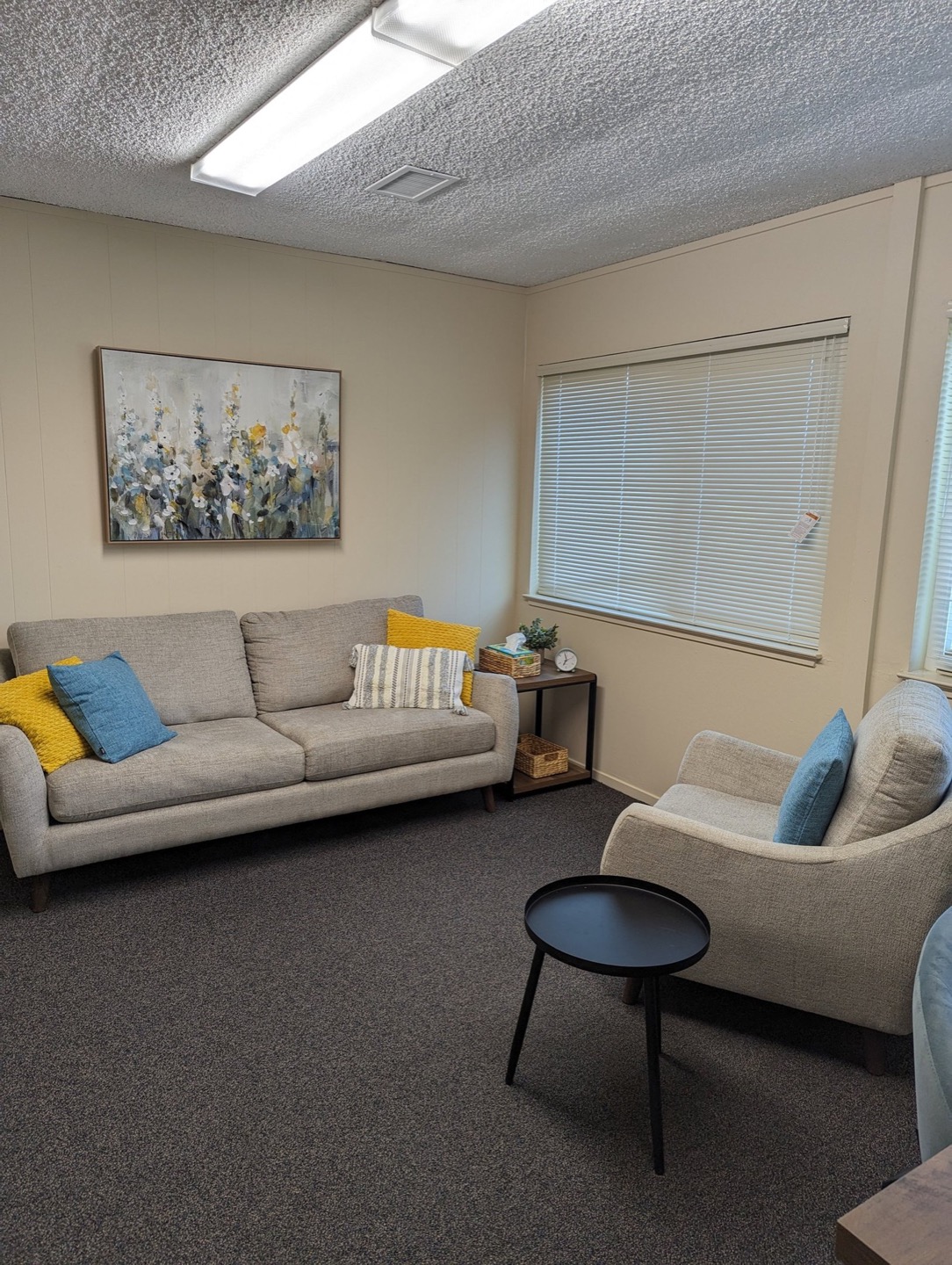 Comfortable therapy office with sofa and natural light in Los Altos, CA